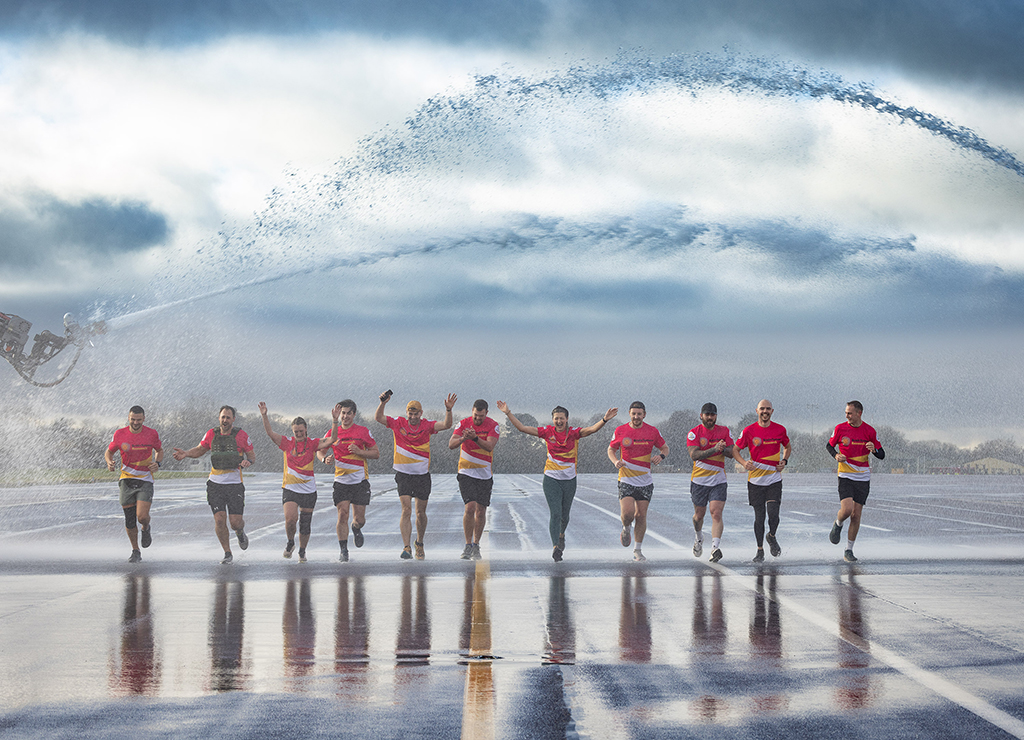 The team seen running line abreast through a water arch, created by two Station Fire appliances on the Station runway.